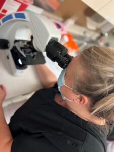 TVUC Nurse analysing urology samples under microscope